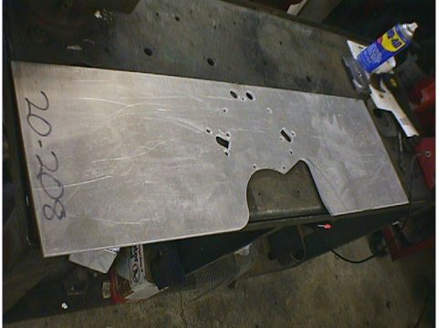 1960 Ford Falcon - A metal plate with pre-drilled holes and a handwritten number is shown on a workbench.