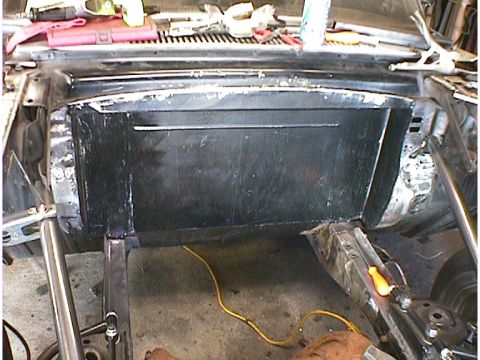 1960 Ford Falcon - This photo shows the firewall area of a car undergoing repairs, with a black panel and tools visible.