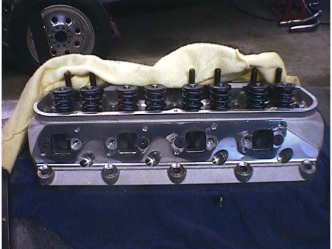 1960 Ford Falcon - Close-up of an engine cylinder head, showing valve springs and pushrods, with a cloth covering part of it.