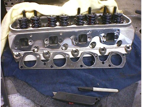 1960 Ford Falcon - A disassembled engine cylinder head and gasket are shown, with tools laid out on a blue cloth.