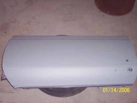 1960 Ford Falcon - A single car door, likely a Ford Falcon, is shown in primer with a date stamp and website logo visible.