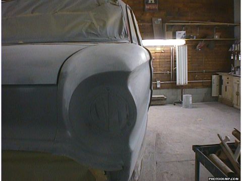 1960 Ford Falcon - A car body, likely a 1960 Ford Falcon, is prepped for painting in a workshop.