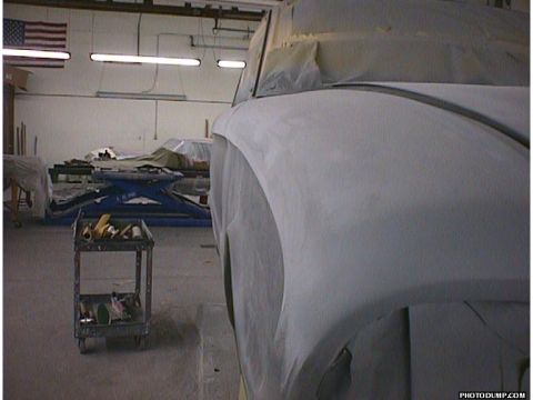 1960 Ford Falcon - A car undergoing bodywork in a workshop, with tools and equipment visible in the background.