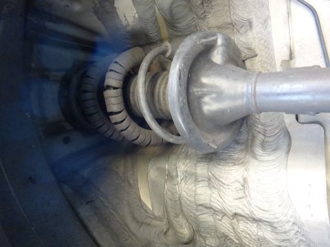 2003 Ford Taurus - This image shows a vehicle's suspension strut and spring, a component crucial for ride comfort and handling.