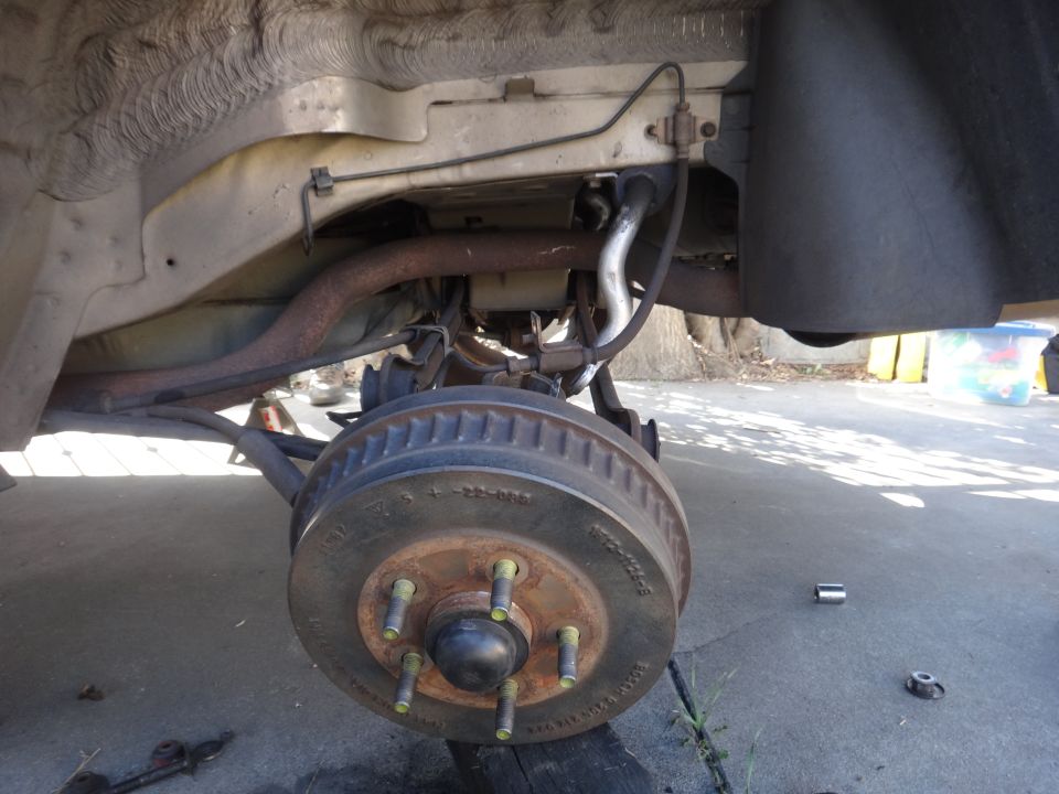 Rear brake drum and suspension components of a vehicle