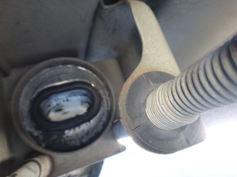 2003 Ford Taurus - Close-up view of a vehicle's suspension strut and bushing assembly.