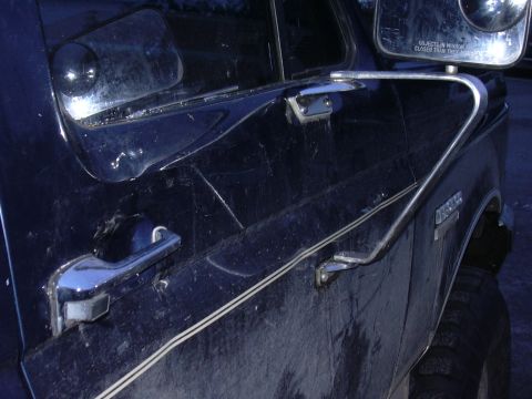 1991 Ford Bronco - This is after I popped some of the dent out. Luckily the glass didn't break and still roles up and down!