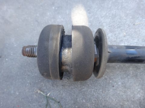 2003 Ford Taurus - This is a close-up view of a vehicle's sway bar end link, showing worn rubber bushings.