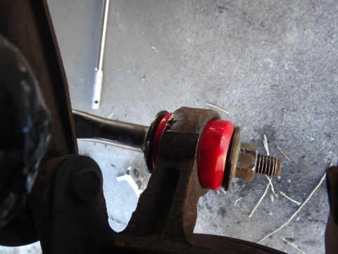 2003 Ford Taurus - Suspension part with red bushings and hardware, likely a control arm bushing.