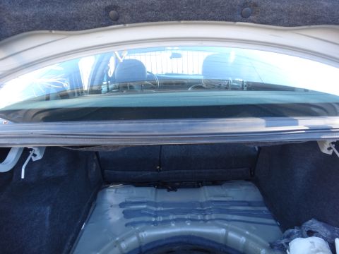 2003 Ford Taurus - View from inside a car's trunk, looking forward through the rear window towards the interior.