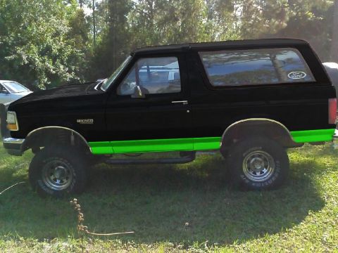 1994 Ford Bronco - This 1994 Ford Bronco features a two-tone paint scheme with black and bright green accents.