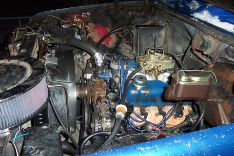 1980 Ford Bronco - Close-up view of an engine bay, showing the carburetor and air filter assembly.