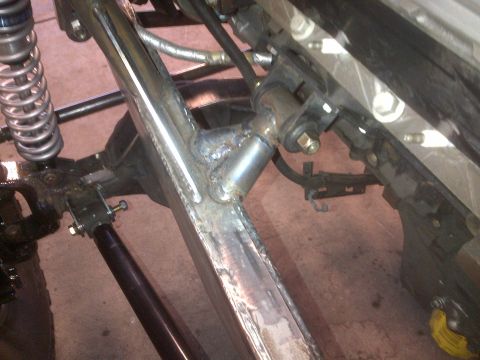 1985 Jeep CJ7 - Close-up view of a custom off-road vehicle's suspension and frame modifications.