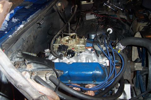 1980 Ford Bronco - Engine bay view showing the carburetor and Ford valve covers, with wiring and hoses visible.