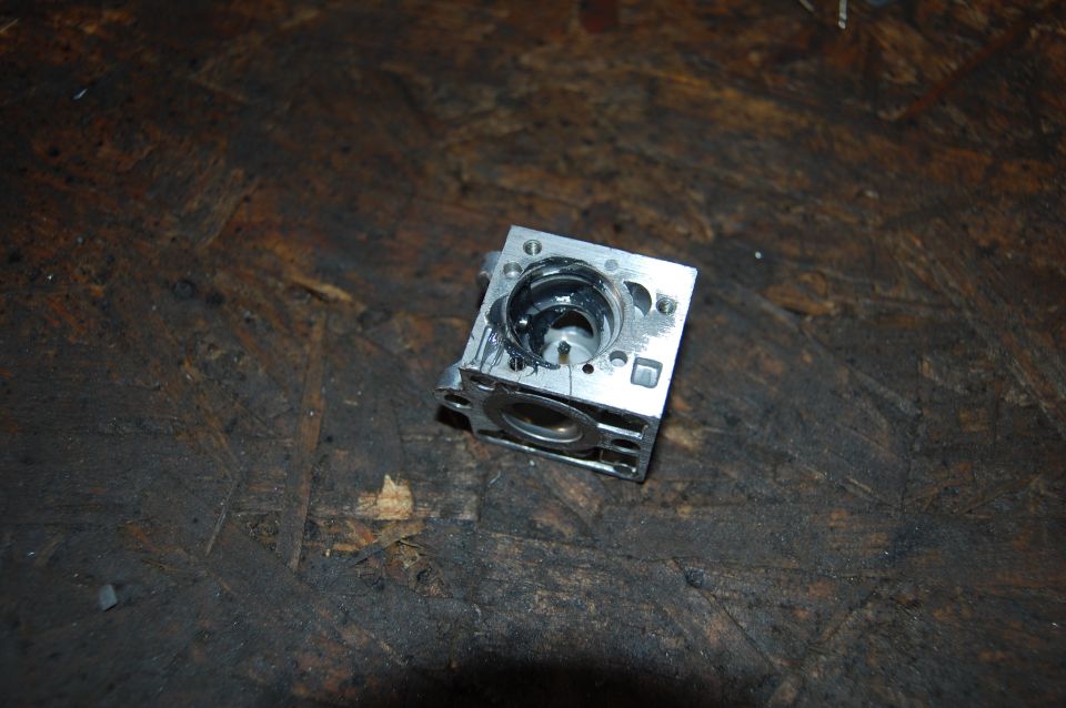 Carburetor part on wooden surface