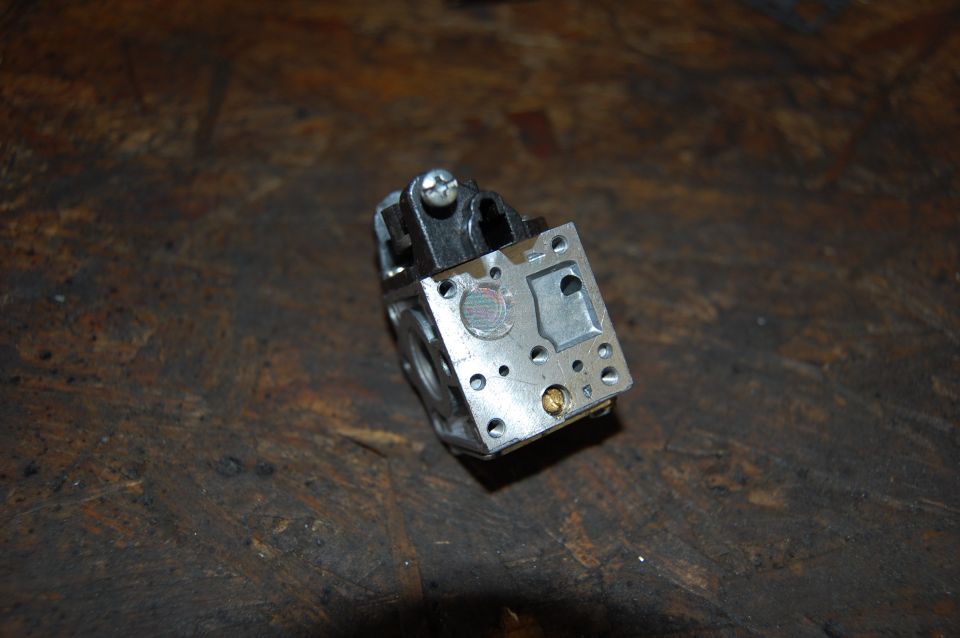 Carburetor part on wooden surface