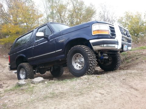 1995 Ford Bronco - This 1995 Ford Bronco is shown navigating a rough, unpaved terrain.