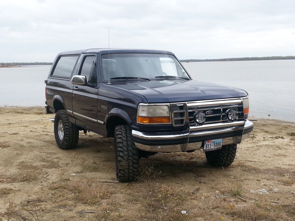 Dark blue 1995 Ford Bronco parked by a lake