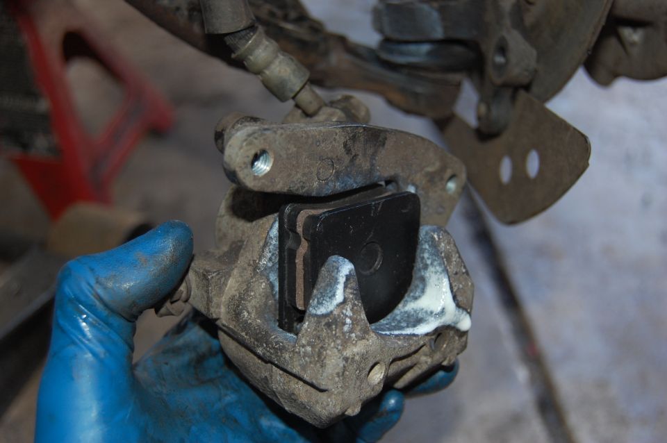 Brake caliper with new pads being installed