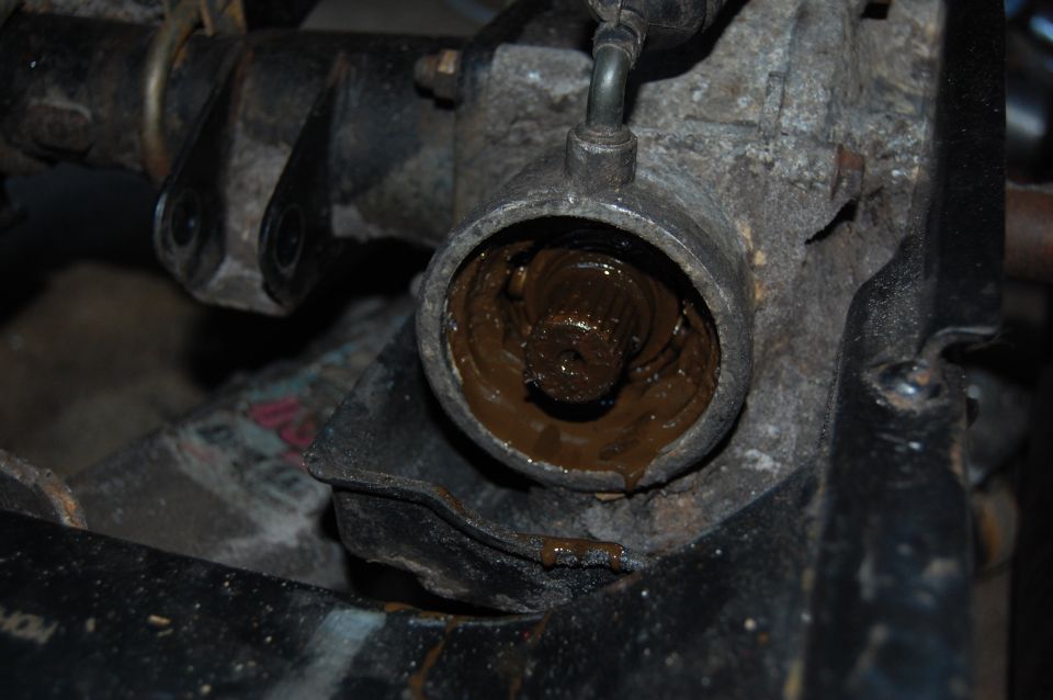 Close-up of a greasy mechanical component with visible splines