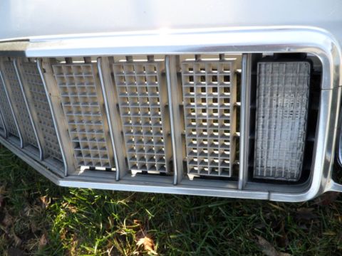 1994 Jeep Cherokee - The distinctive grille and headlight of a 1984 Jeep Cherokee are visible in this close-up shot.