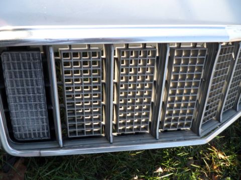 1994 Jeep Cherokee - Close-up of the front grille and headlight assembly on a 1994 Jeep Cherokee.