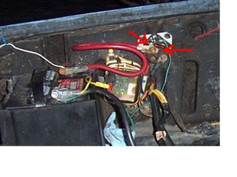 1980 Ford Bronco - Close-up view of the battery and starter solenoid wiring, with red arrows highlighting specific connection points.