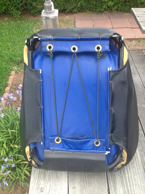 1986 Ford Bronco - The underside of a car seat with blue fabric and black side panels is shown.