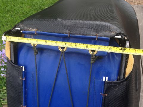 1986 Ford Bronco - A measuring tape is placed across the top of a car seat cover, detailing its dimensions.