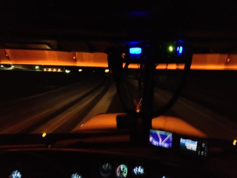 2003 Peterbilt 379 - Nighttime view from inside a truck, showing illuminated dashboard screens and ambient orange lighting along the cabin.