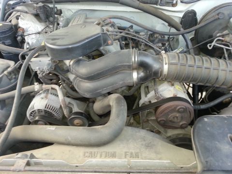 1996 Ford Bronco - Engine bay of a 1996 Ford Bronco, showing the V8 engine and associated parts.
