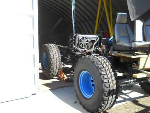 1992 Ford Bronco - Chassis of an off-road vehicle undergoing work, showing the engine and interior components.
