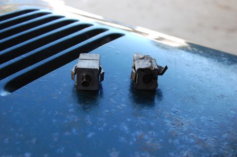 2006 Honda RANCHER - Two metal brackets are shown on a blue surface, with a grille visible in the background.