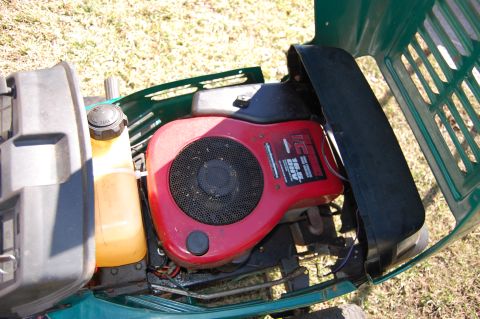 2006 Honda RANCHER - Engine detail on a lawn mower, showing the "IC 16.5 HP OHV" label on the red casing.