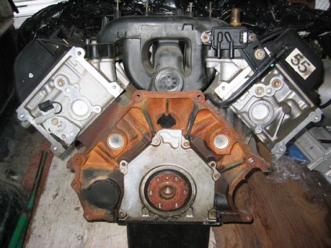 1996 Ford Crown Victoria - Close-up view of a V8 engine, showing the block, intake, and valve covers. A numerical sticker is affixed to one component.