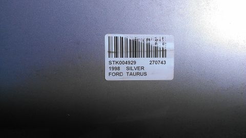 1990 Ford Bronco - A close-up of a sticker on a vehicle door indicates it is a 1998 Ford Taurus in silver.