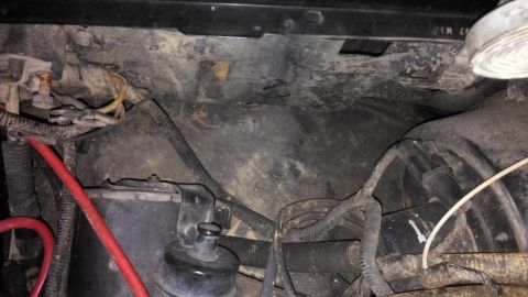 1990 Ford Bronco - Close-up view of engine bay wiring and components, showing a section of the battery area.