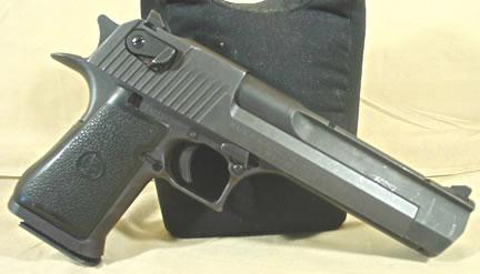 1995 Ford Bronco - A close-up view of a pistol, showing its metallic slide and textured grip.