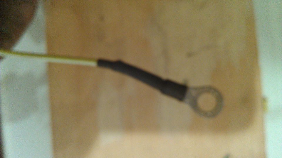 Electrical wire with black heat shrink and a ring terminal, Supermotors logo visible