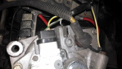 1990 Ford Bronco - Detail of alternator wiring, showing red and yellow electrical connections.