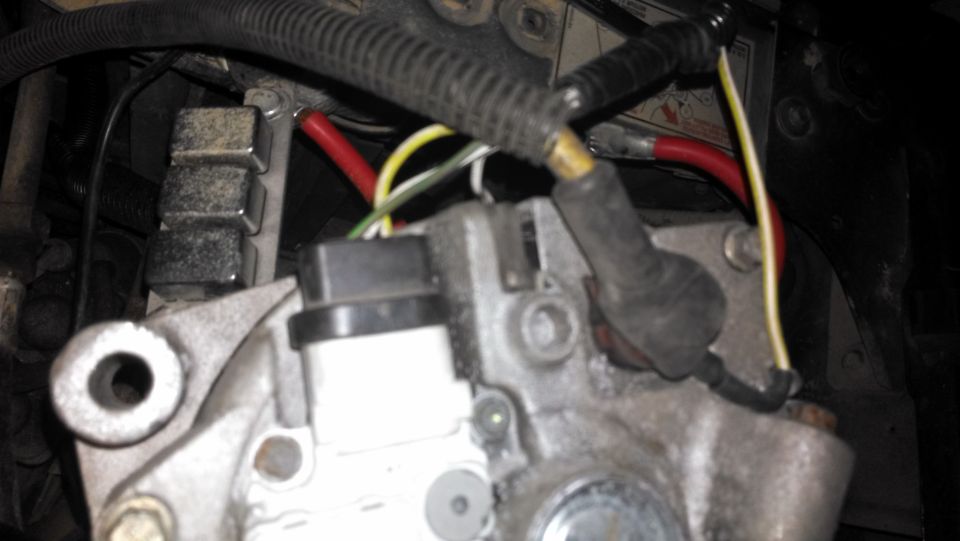 Close-up of alternator wiring with red and yellow cables