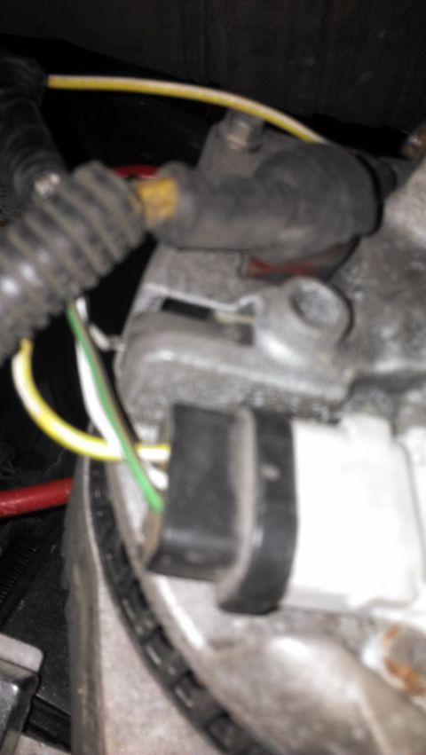 1990 Ford Bronco - The image shows a close-up view of electrical wiring connected to a vehicle's alternator.