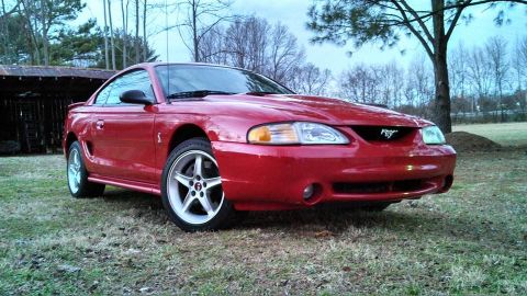 1997 Ford Mustang - Front 3/4 view of a red 1997 Ford Mustang Cobra.
