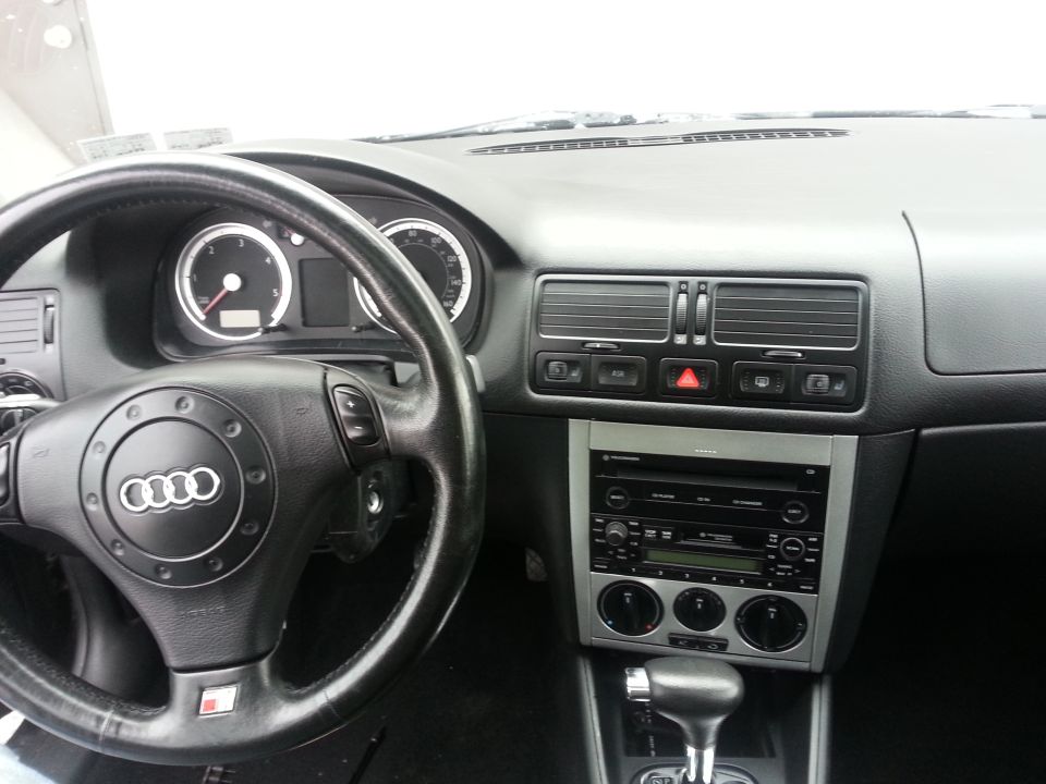 Interior view of a car with an Audi steering wheel and Volkswagen radio