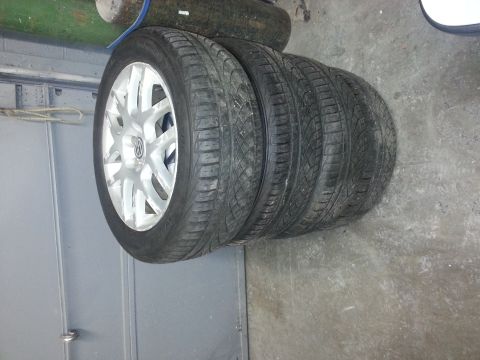 2002 Volkswagen Jetta - Four stacked tires with silver rims are visible, with one rim displaying a Volkswagen logo.