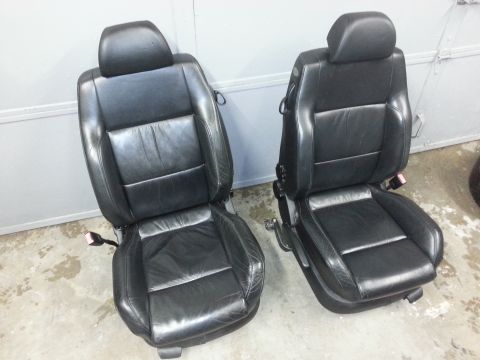 2002 Volkswagen Jetta - A pair of black leather car seats are shown in a garage setting.