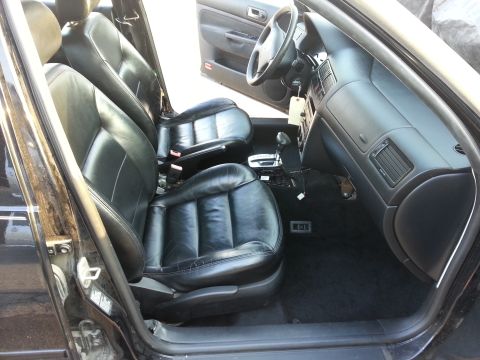 2002 Volkswagen Jetta - The interior of a 2002 Volkswagen Jetta features black leather seats and a dark dashboard.