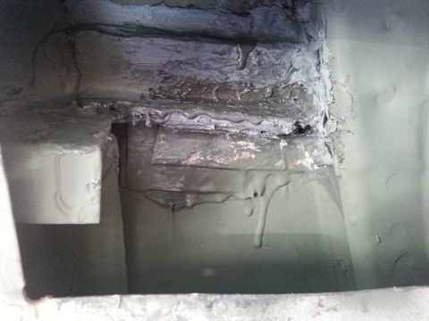 1992 Ford Bronco - Close-up view of underbody rust repair work, showing sealant and patched metal sections.