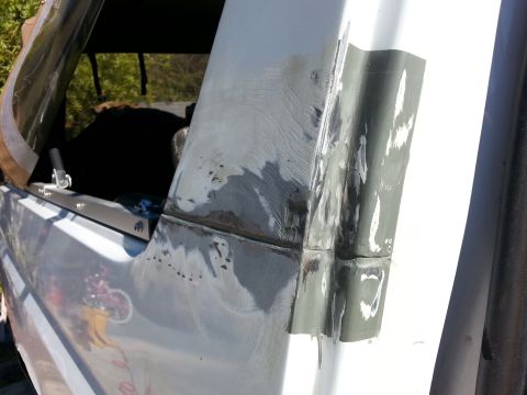 1992 Ford Bronco - Body panel repair work in progress, showing filler and primer application.