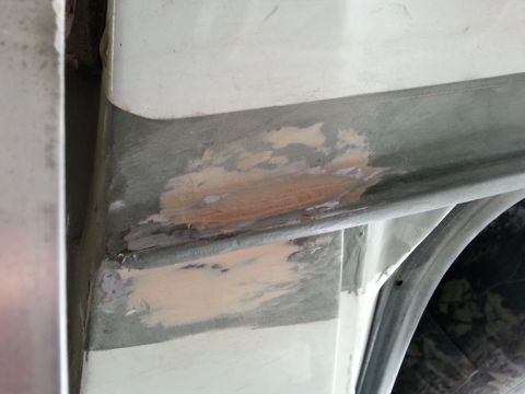 1992 Ford Bronco - Close-up of bodywork repair, showing primer and filler applied to the drip rail area of a vehicle.